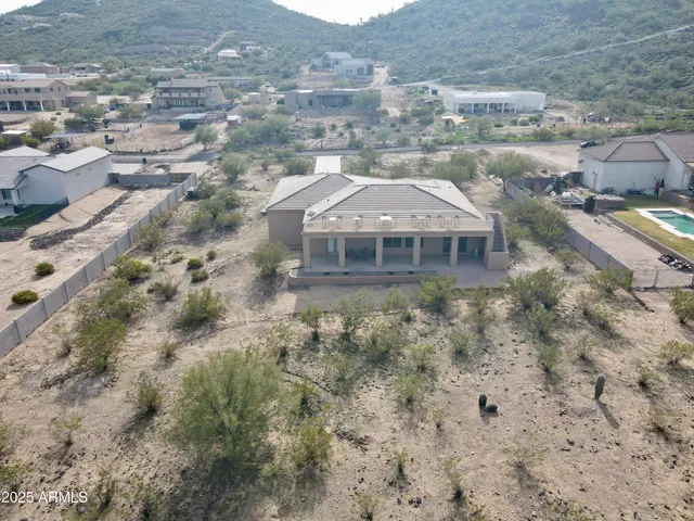 an aerial view of a house with a yard
