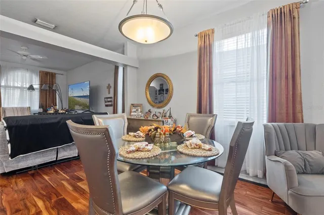 a view of a dining room with furniture and wooden floor