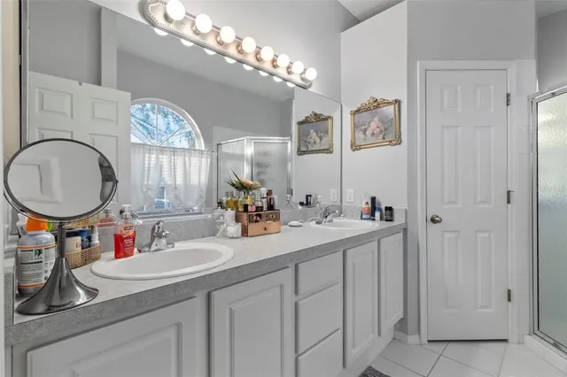a en suite spacious bathroom with a granite countertop tub and a large window