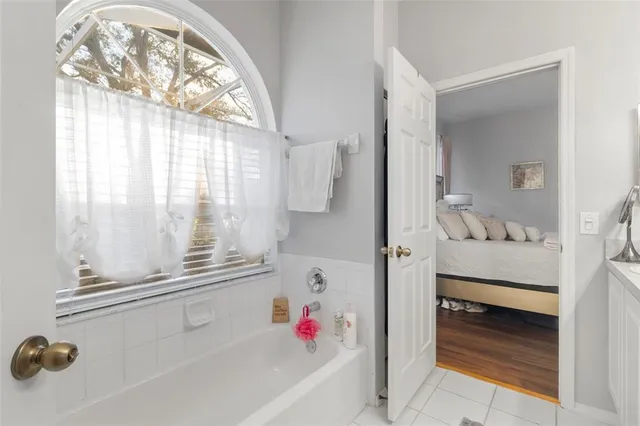 a bedroom with a bed table and a lamp