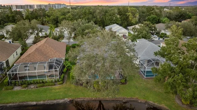 an aerial view of residential houses with outdoor space and river