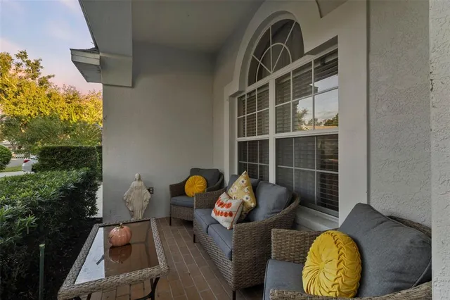 a view of backyard with table and chair and potted plants