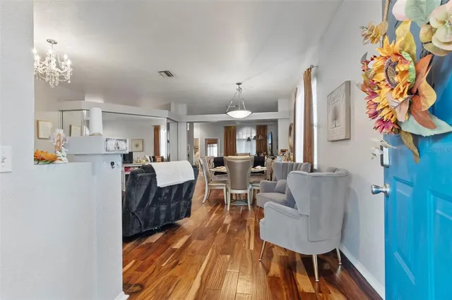 a living room with furniture and a chandelier