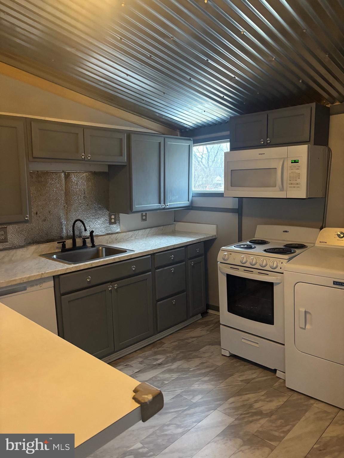 91 Middle Road Elkton, MD 21921 - Photo 4 of 11 a kitchen with a stove sink and cabinets