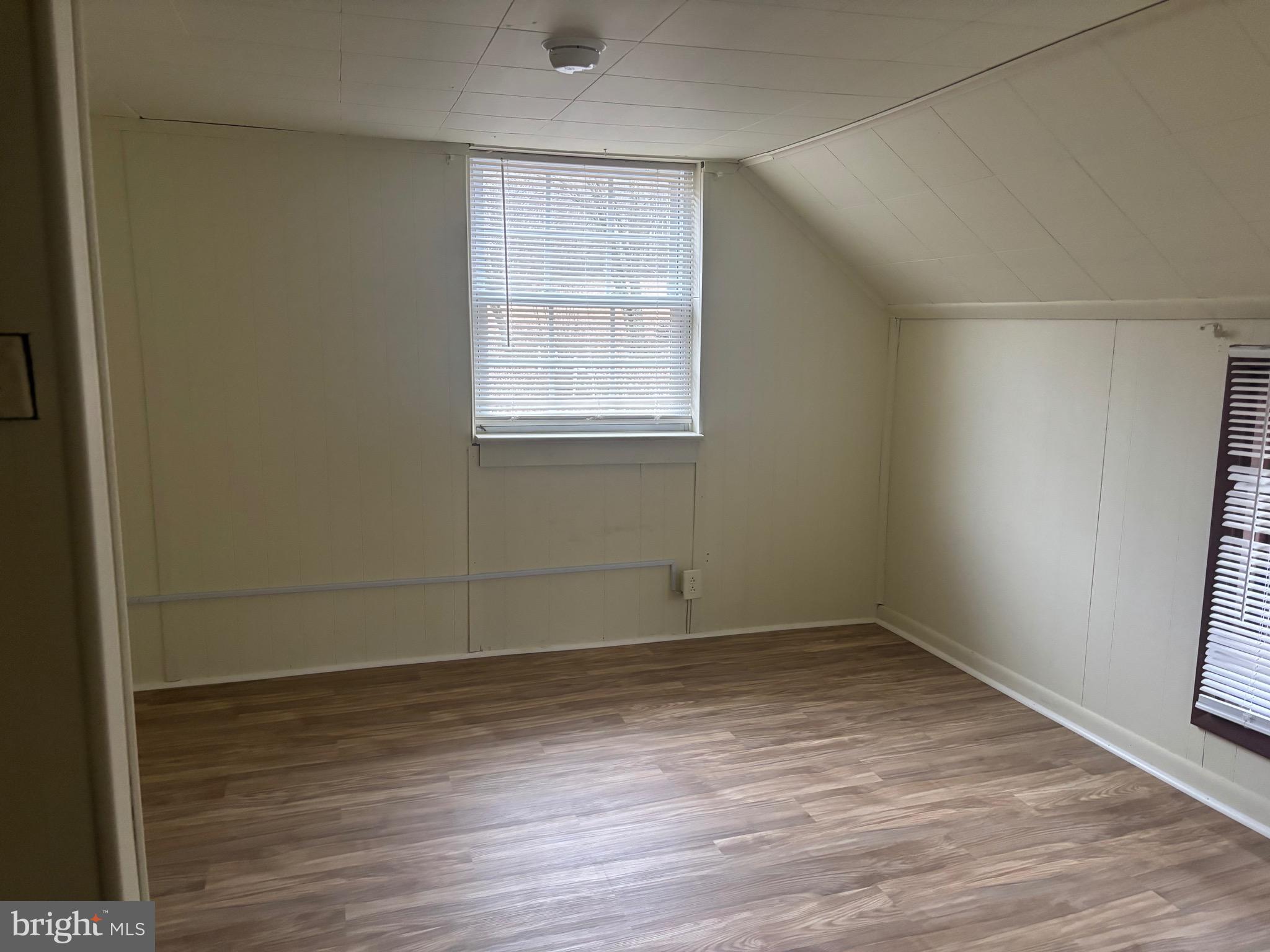91 Middle Road Elkton, MD 21921 - Photo 7 of 11 an empty room with wooden floor and windows