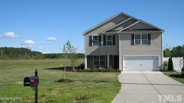 a front view of a house with a yard