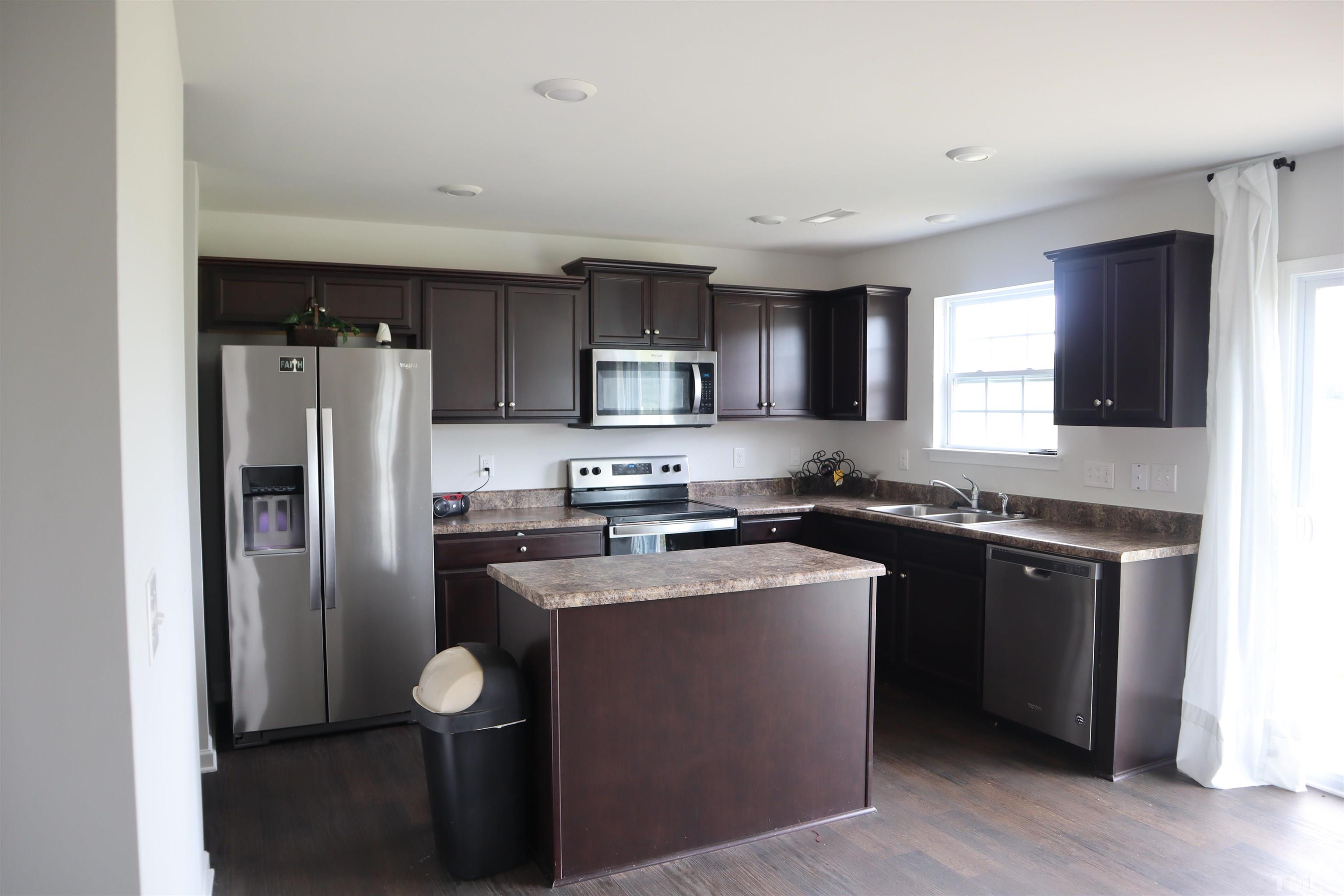 7500 Jordan Road Rocky Mount, NC 27803 - Photo 5 of 5 a kitchen with stainless steel appliances granite countertop a refrigerator stove microwave and sink
