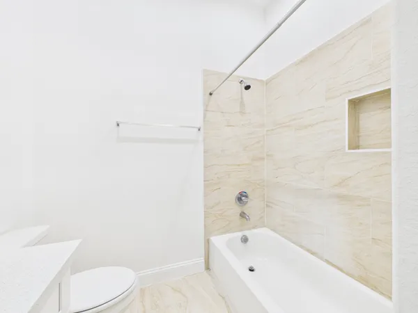 a bathroom with a bathtub and toilet