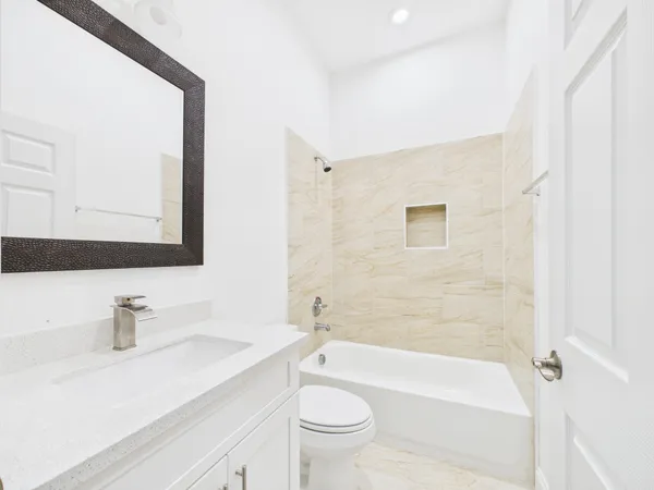 a bathroom with a sink a toilet and a mirror