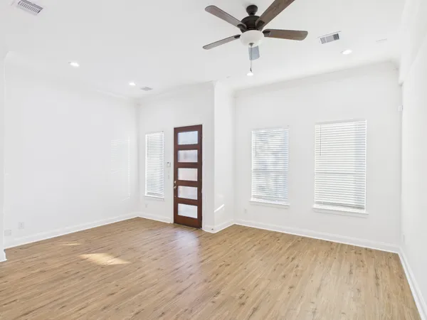 wooden floor in an empty room with a window