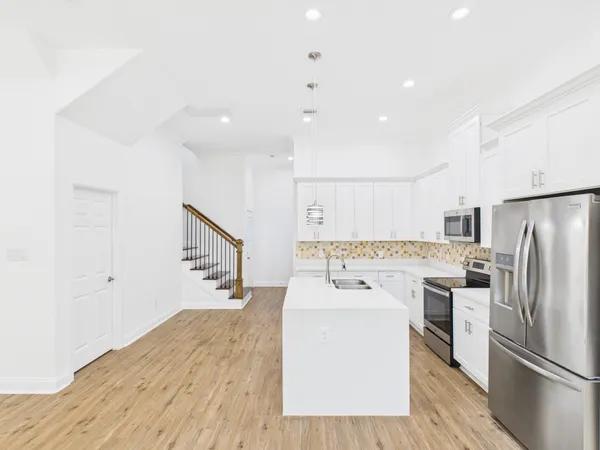 a kitchen with a refrigerator a sink and dishwasher