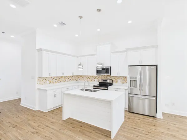 a kitchen with stainless steel appliances a refrigerator stove and sink