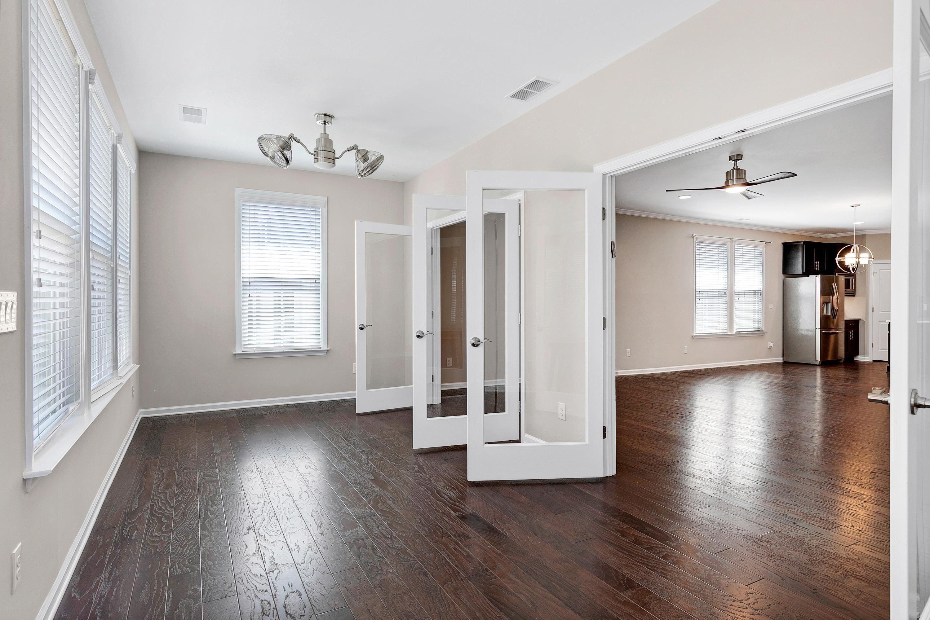 811 Atticus Way Durham, NC 27703 - Photo 11 of 33 an empty room with wooden floor and windows