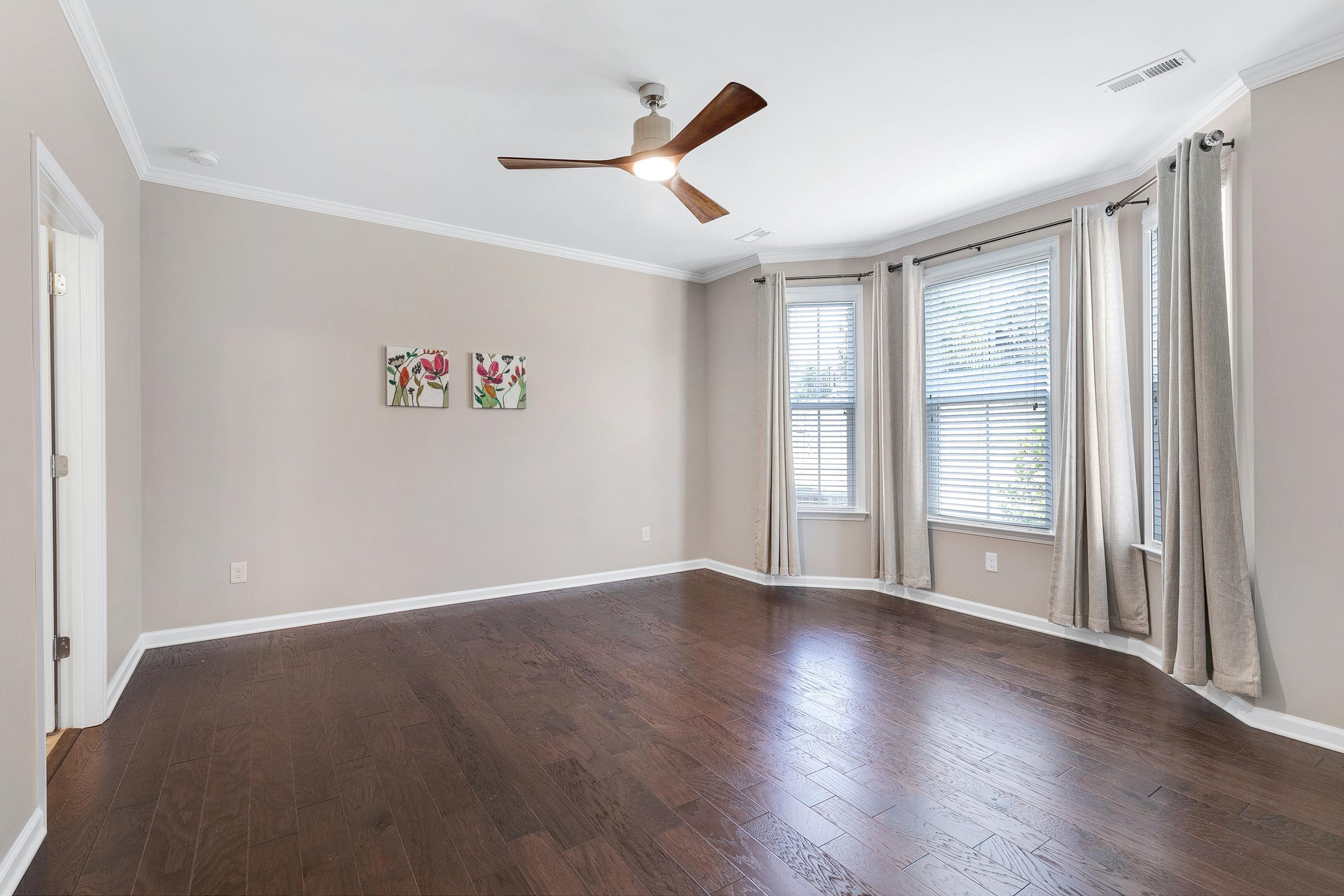 811 Atticus Way Durham, NC 27703 - Photo 13 of 33 an empty room with wooden floor and windows