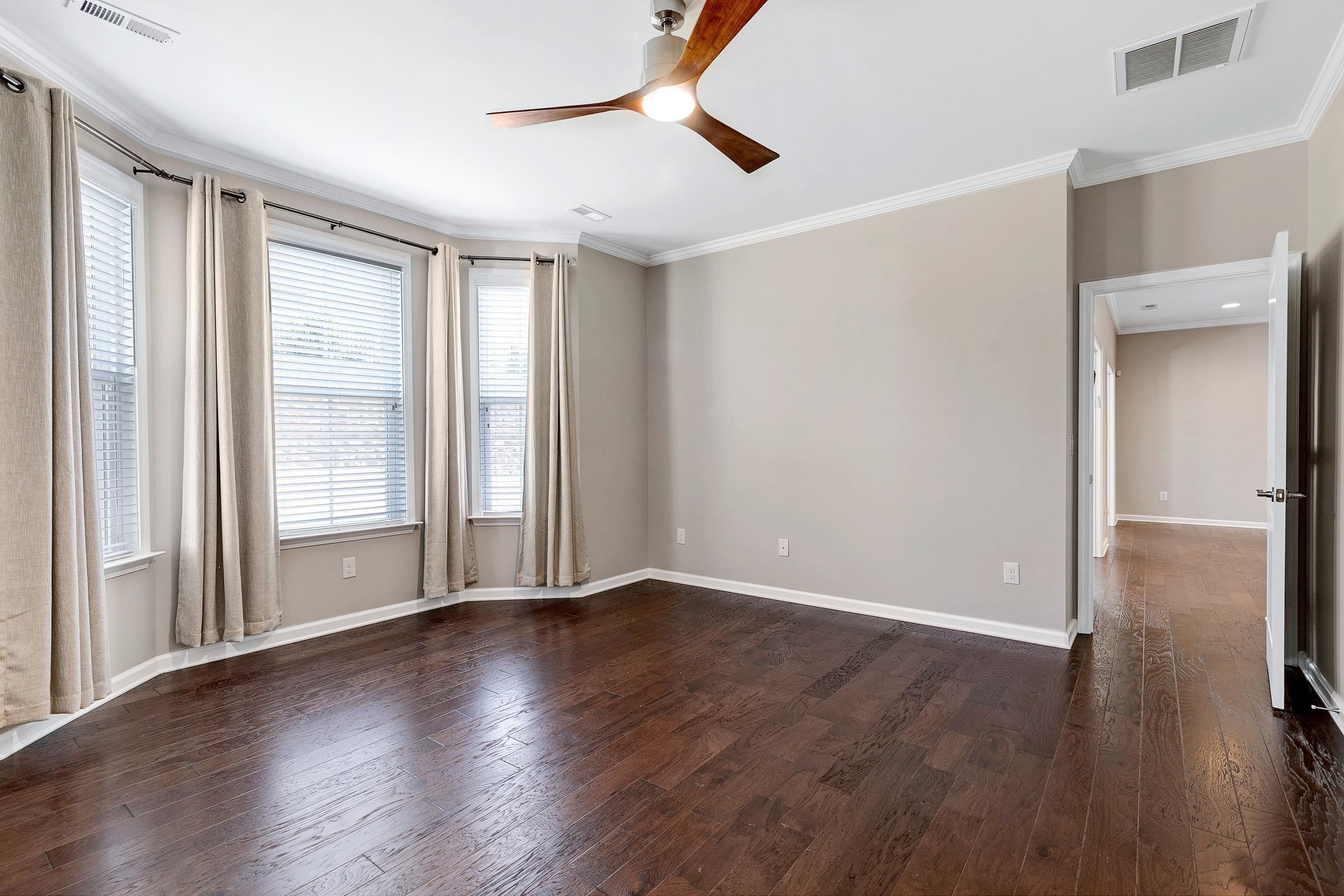 811 Atticus Way Durham, NC 27703 - Photo 14 of 33 an empty room with wooden floor fan and windows