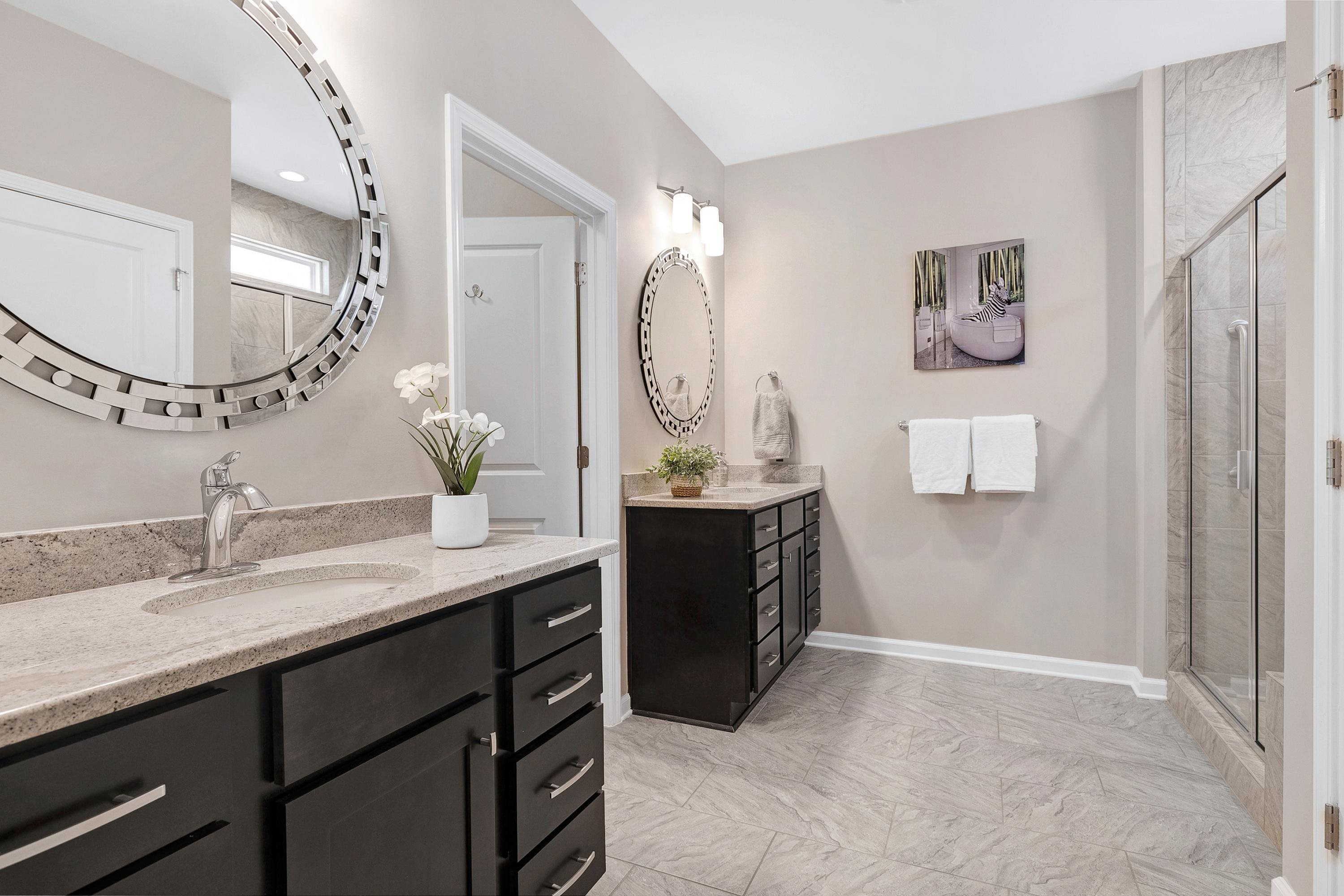 811 Atticus Way Durham, NC 27703 - Photo 15 of 33 a en suite bathroom with a double vanity sink and a mirror
