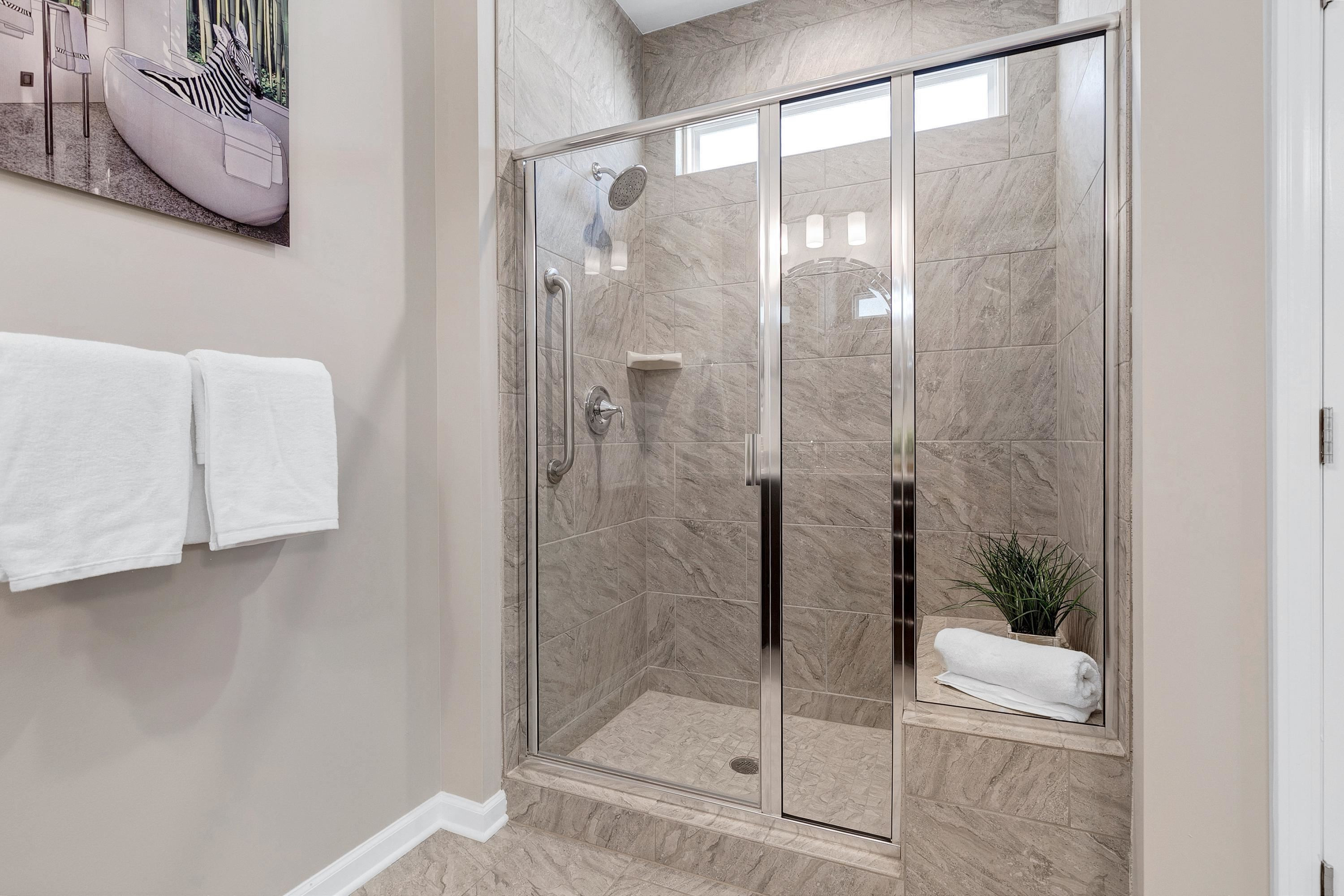 811 Atticus Way Durham, NC 27703 - Photo 16 of 33 a bathroom with a glass shower door