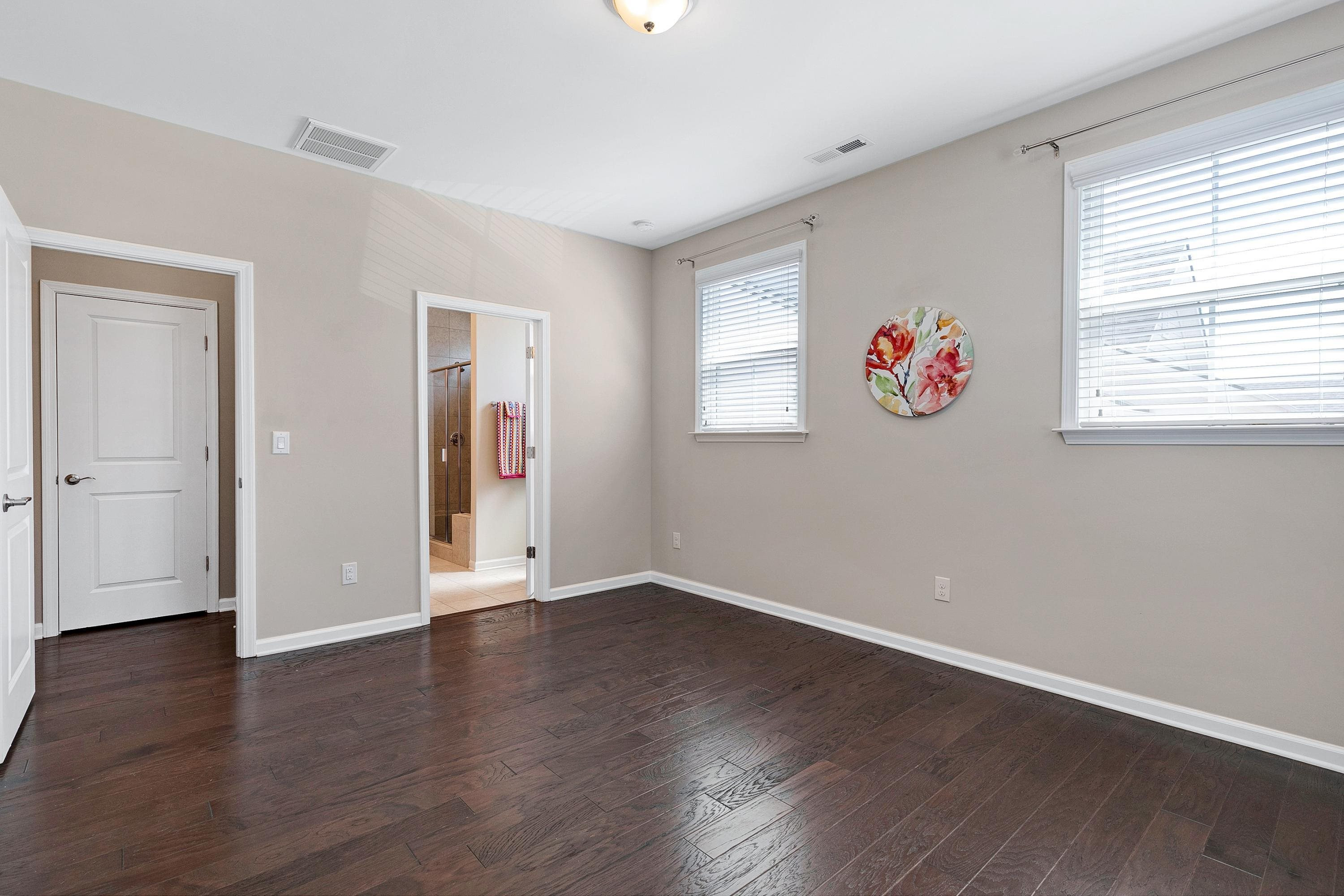 811 Atticus Way Durham, NC 27703 - Photo 18 of 33 a view of an empty room with window and wooden floor