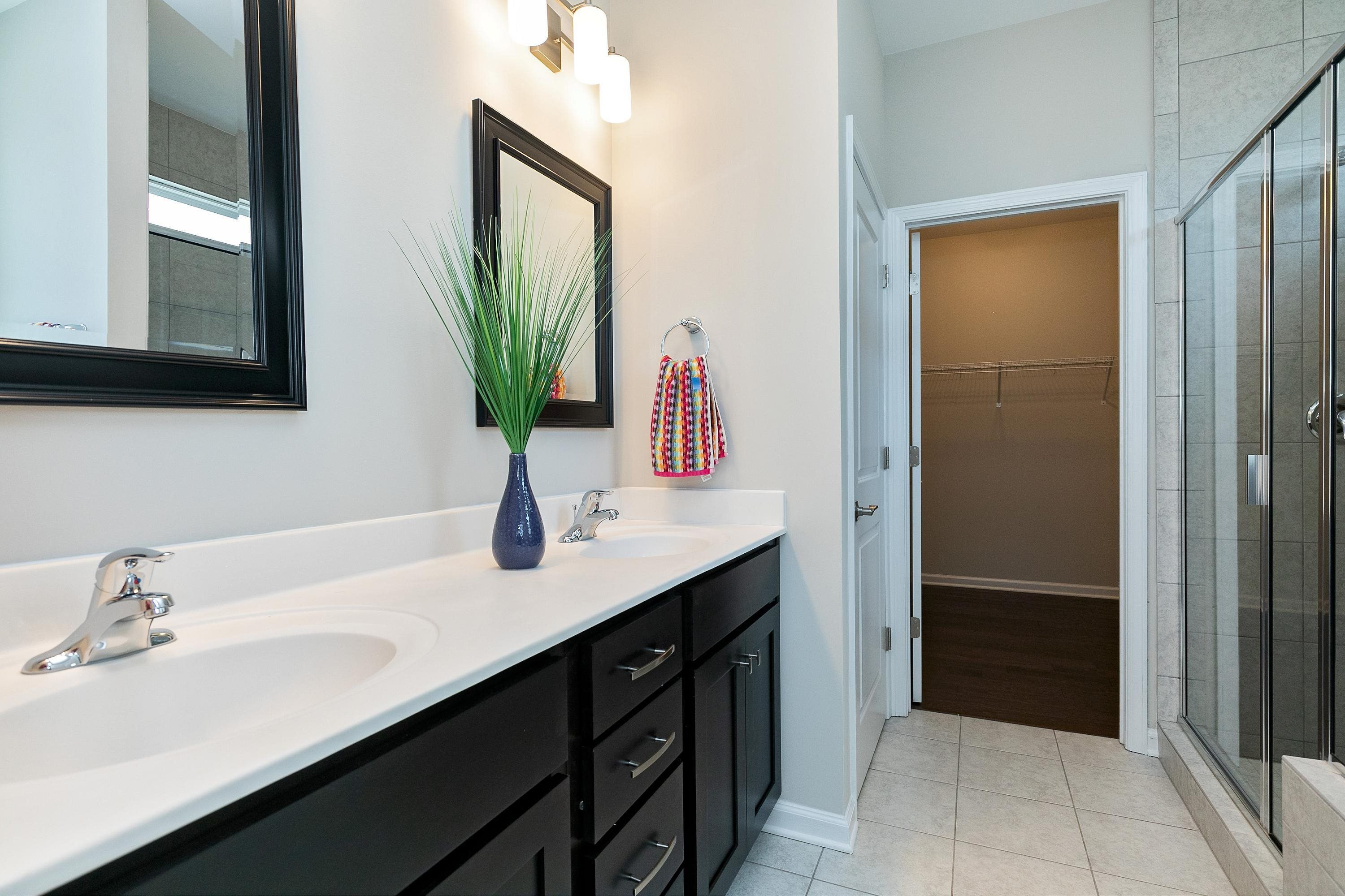 811 Atticus Way Durham, NC 27703 - Photo 19 of 33 a bathroom with a double vanity sink a and mirror