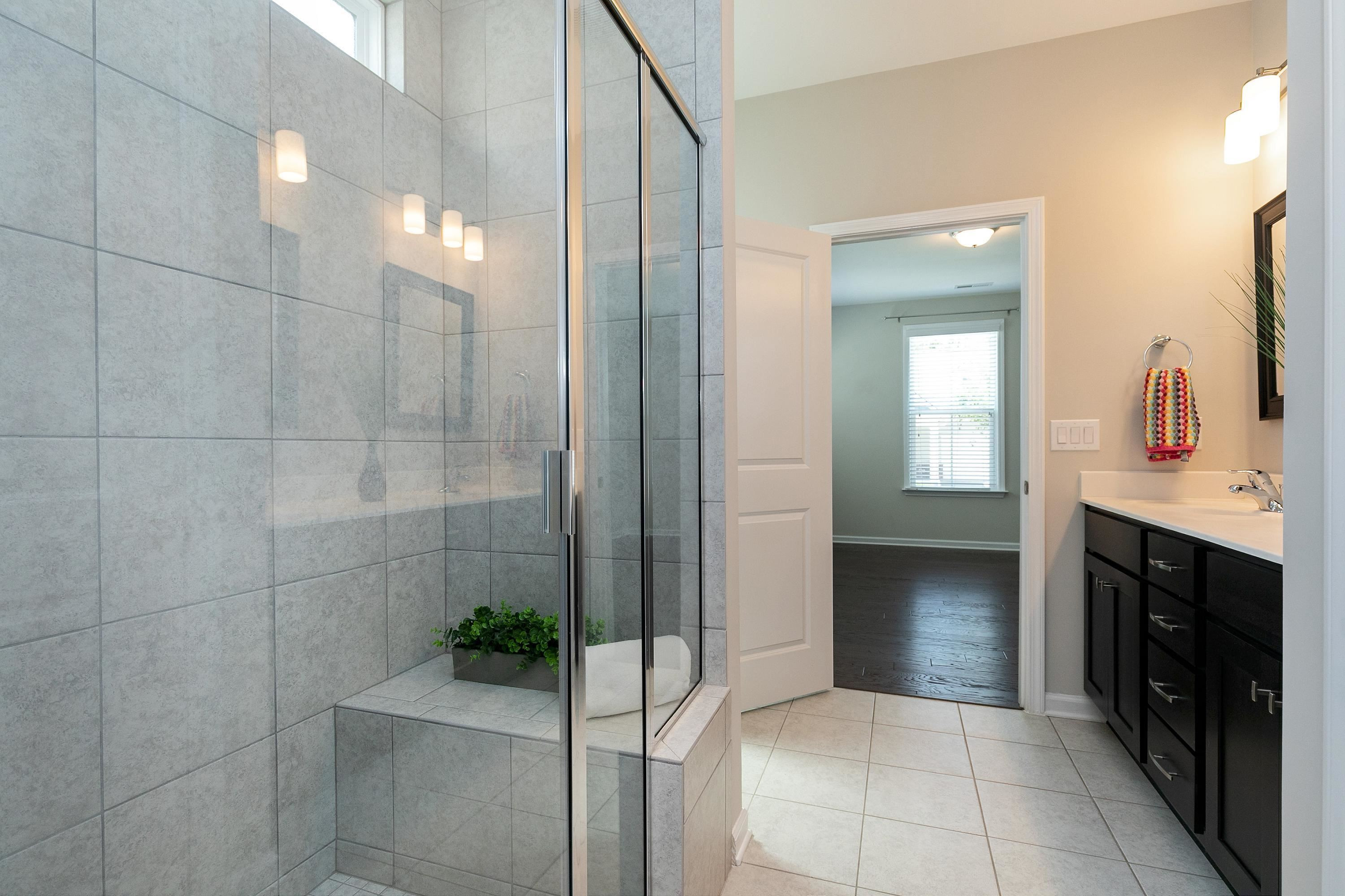 811 Atticus Way Durham, NC 27703 - Photo 21 of 33 a bathroom with a sink and a mirror