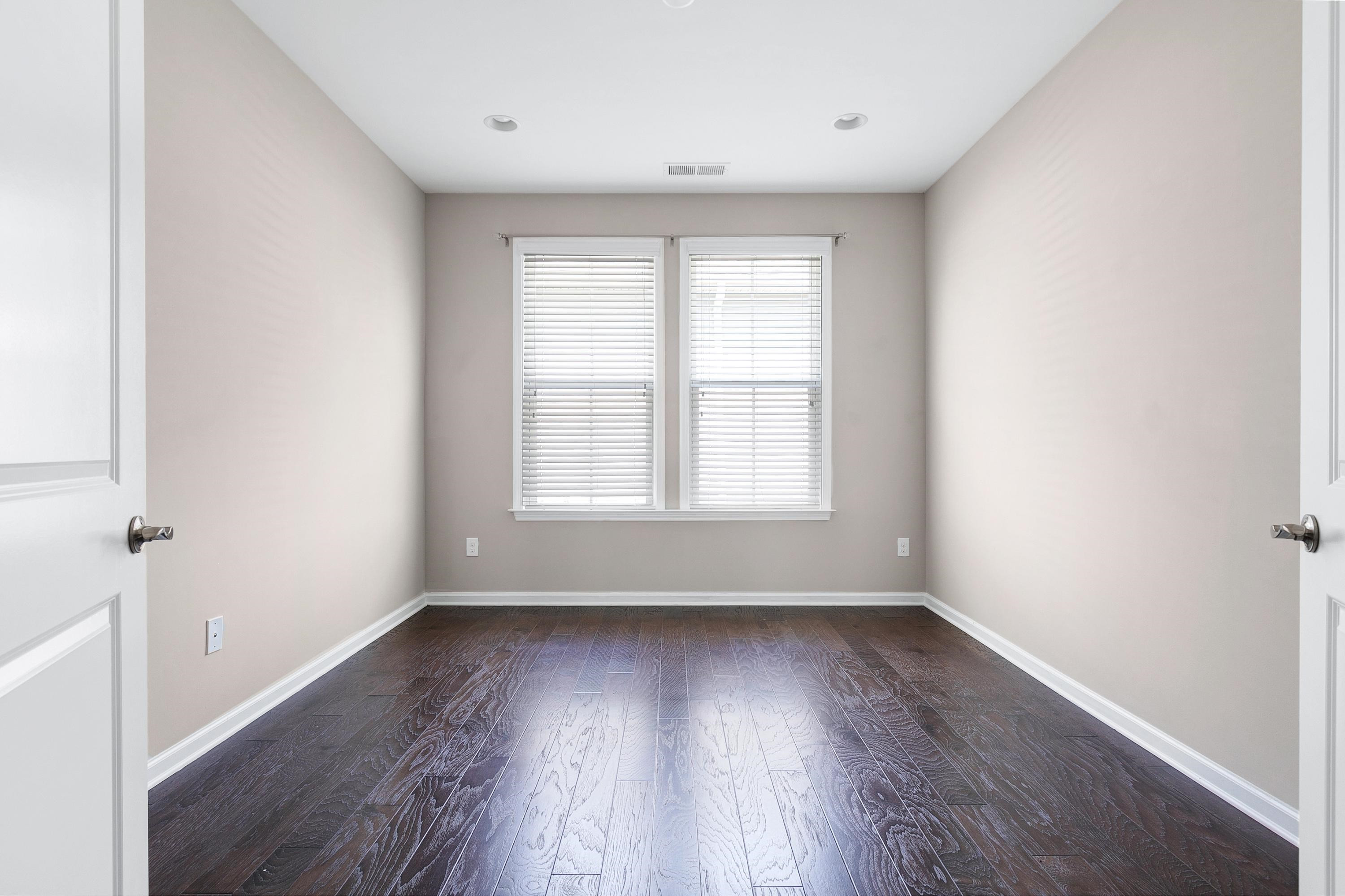 811 Atticus Way Durham, NC 27703 - Photo 23 of 33 an empty room with wooden floor and windows