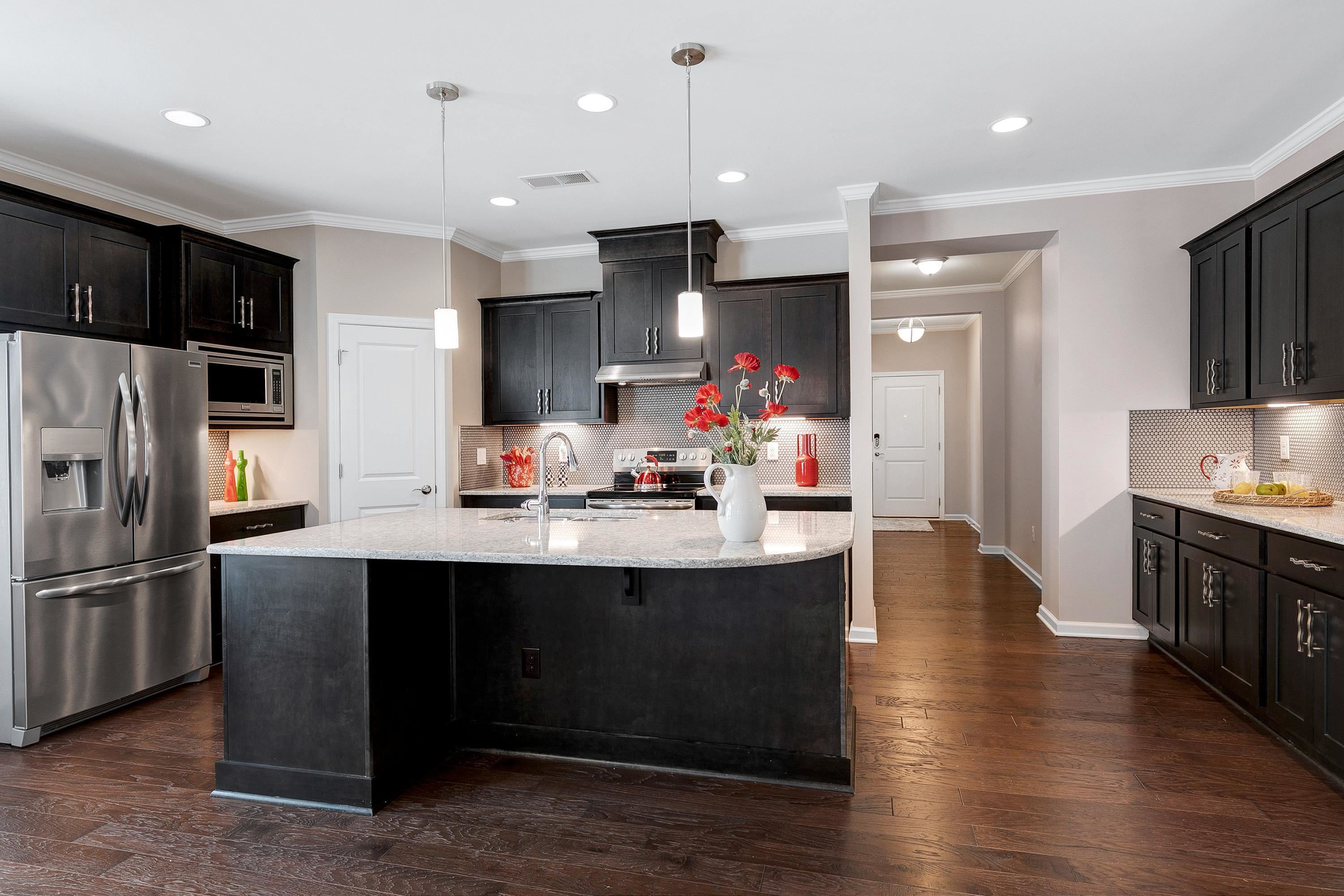 811 Atticus Way Durham, NC 27703 - Photo 4 of 33 a kitchen with counter top space cabinets and stainless steel appliances