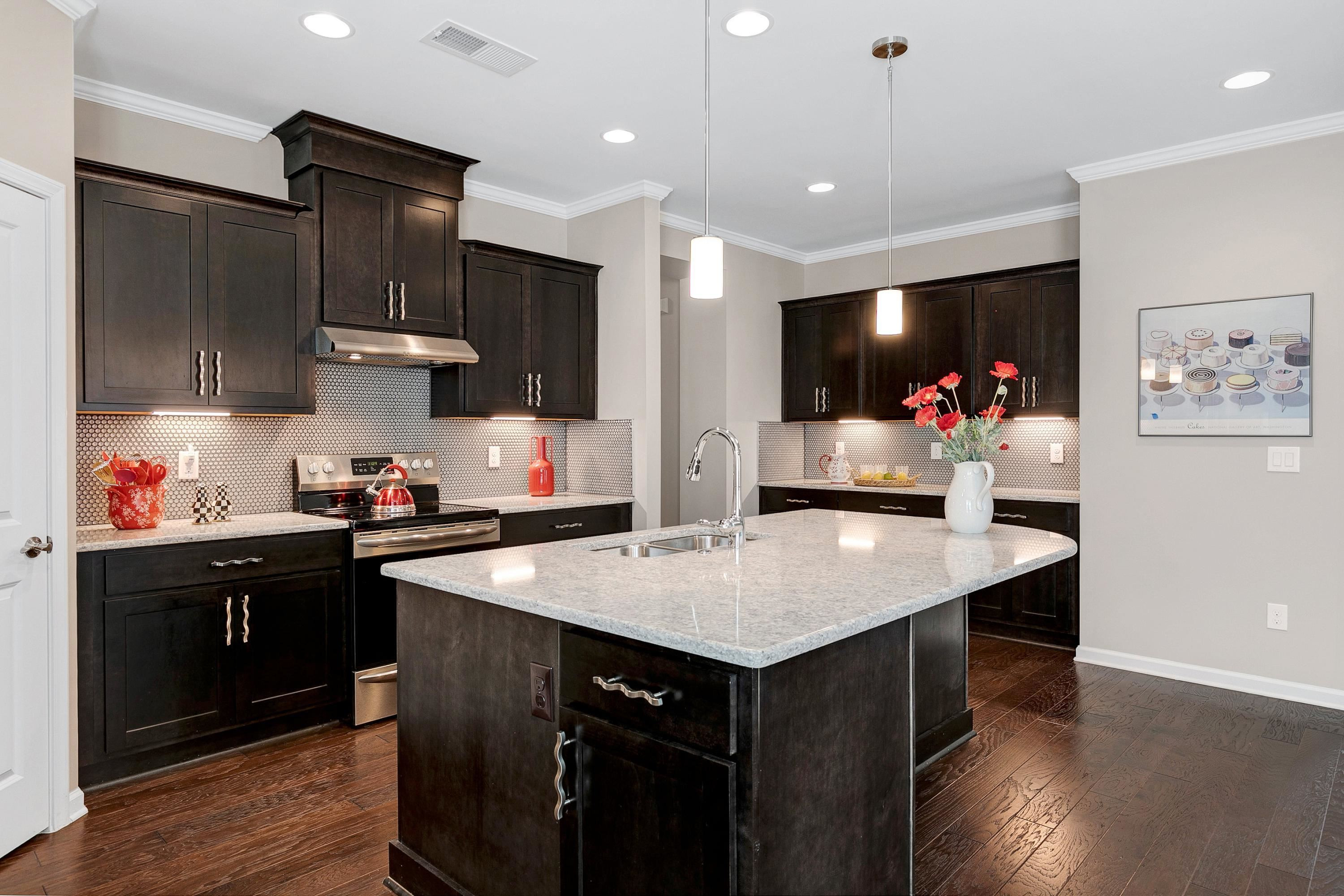 811 Atticus Way Durham, NC 27703 - Photo 5 of 33 a kitchen with granite countertop a sink cabinets and wooden floor