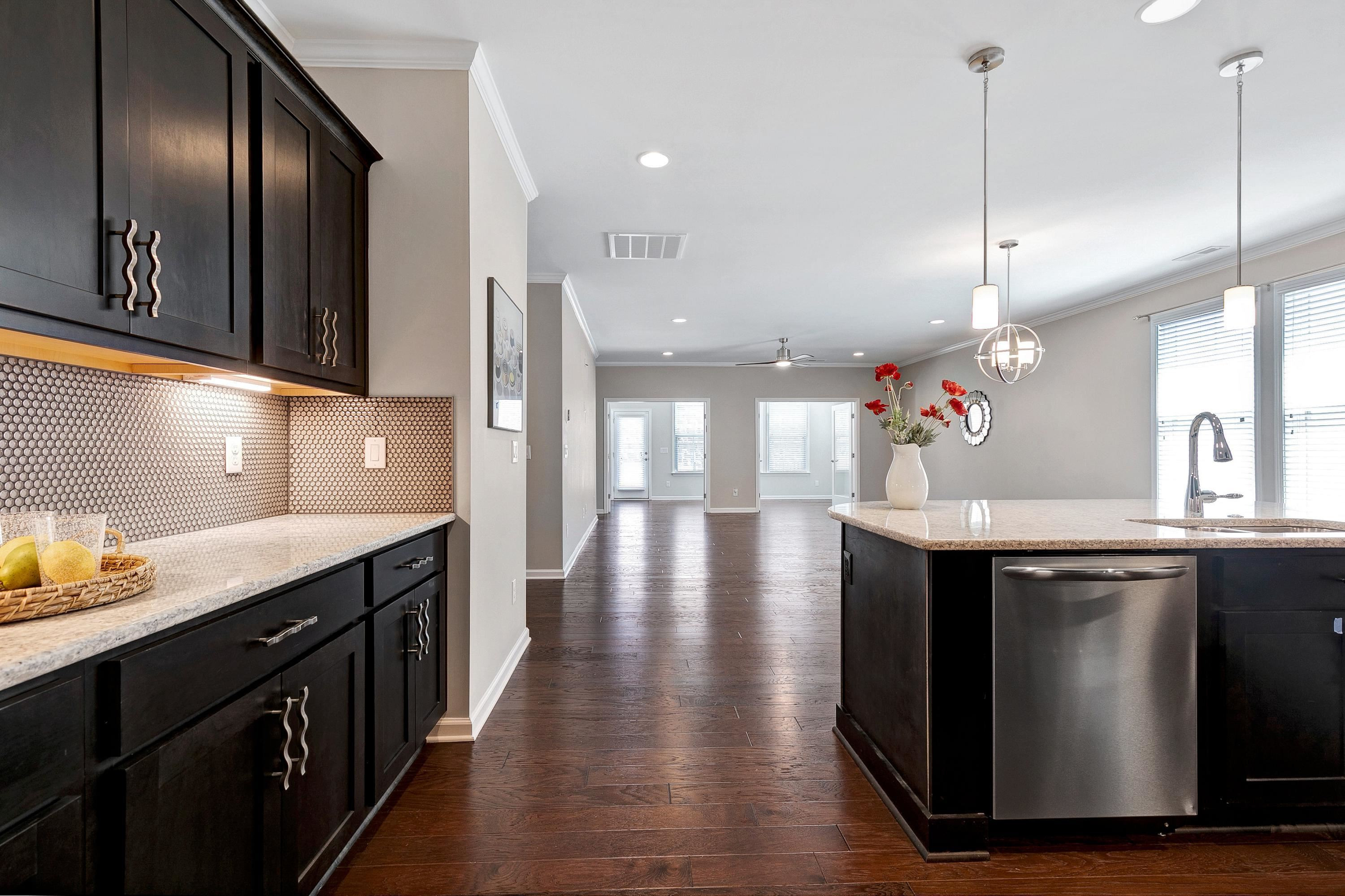 811 Atticus Way Durham, NC 27703 - Photo 7 of 33 a kitchen with stainless steel appliances granite countertop a sink a stove and a wooden floors