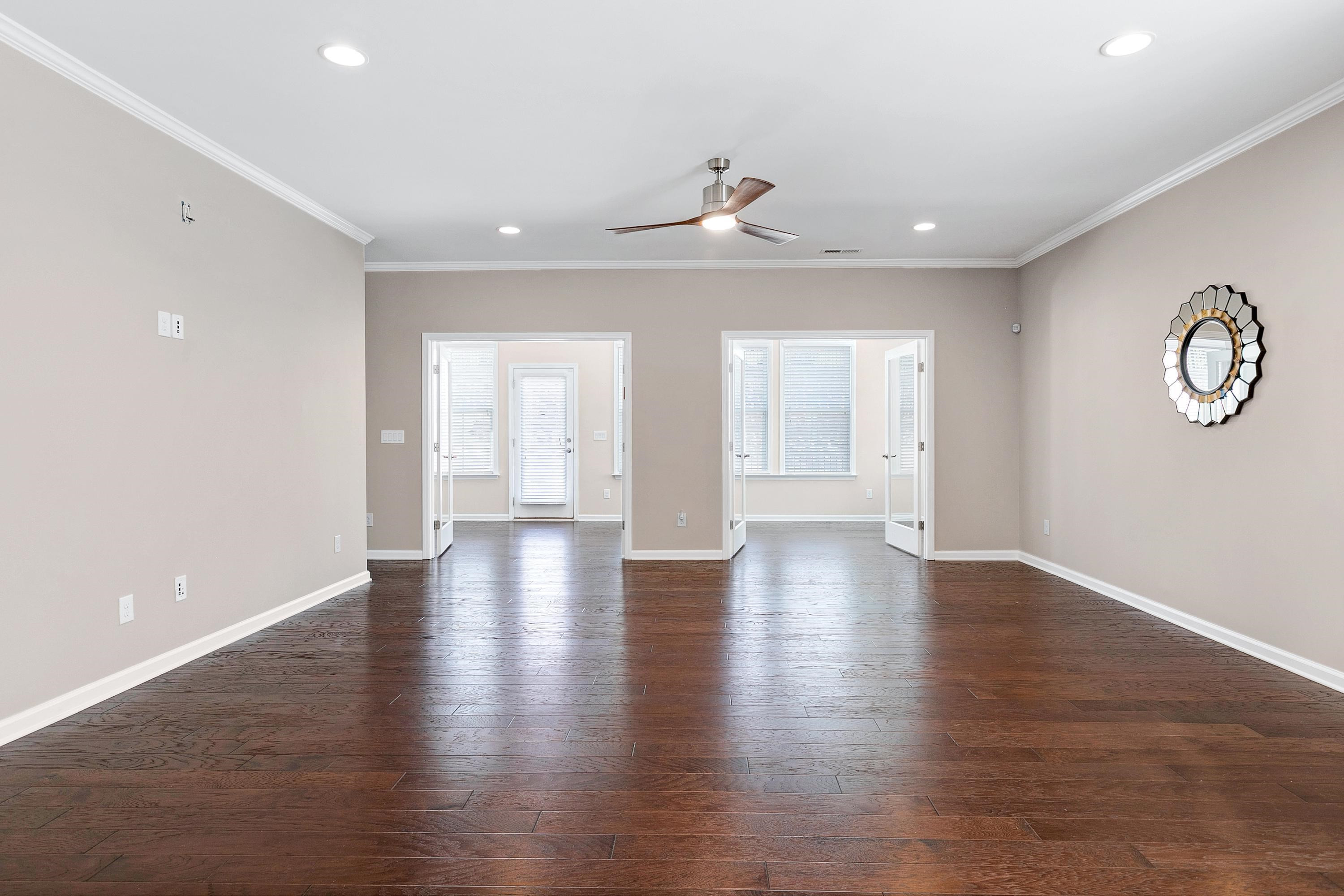 811 Atticus Way Durham, NC 27703 - Photo 10 of 33 a view of an empty room with wooden floor and a window