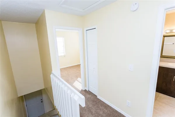 a view of a hallway with wooden floor and entryway