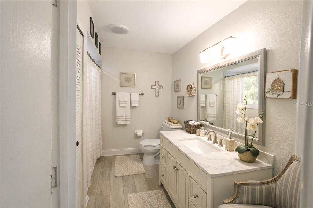 5046 Kenmore Street Spring Hill, FL 34608 - Photo 6 of 19 a bathroom with a double vanity sink mirror and toilet