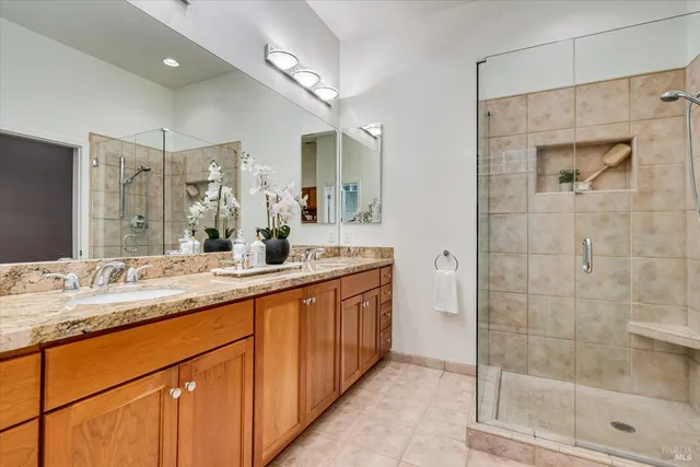 a bathroom with a granite countertop sink mirror and double