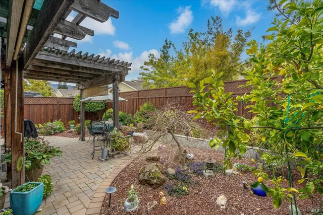a view of a patio with table and chairs potted plants