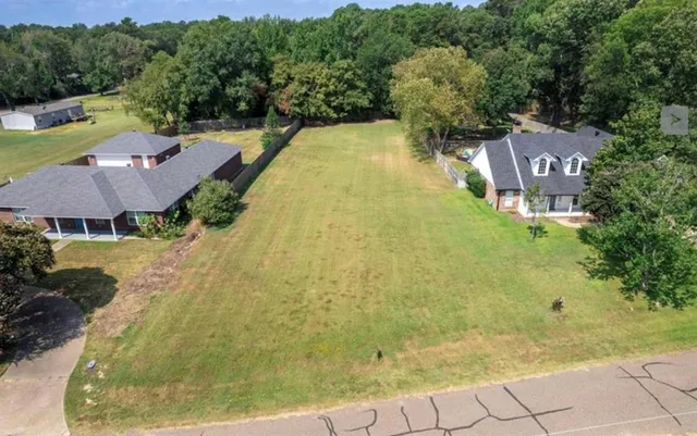 a view of a swimming pool in front of big yard