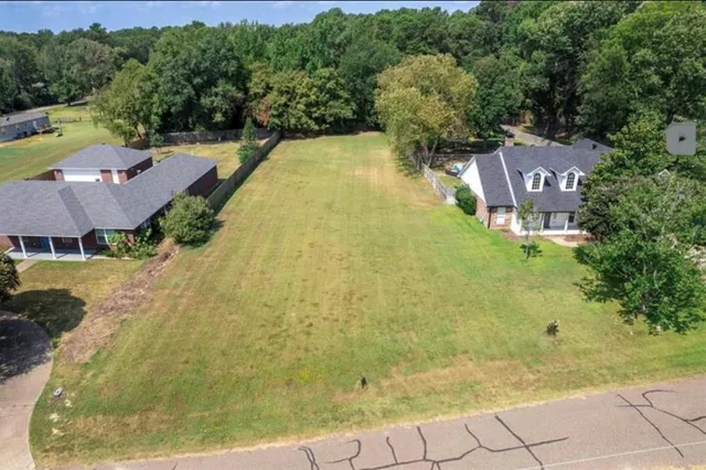 a view of a swimming pool in he middle of the green field