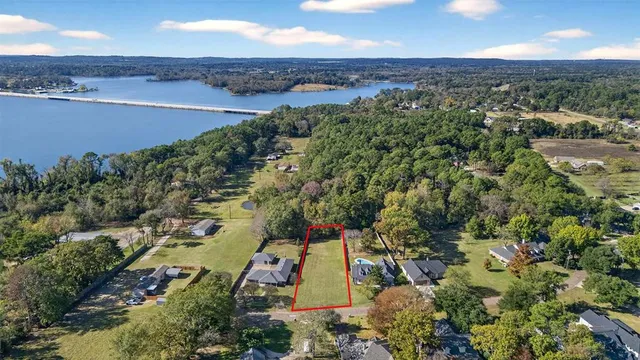 an aerial view of residential houses with outdoor space and river