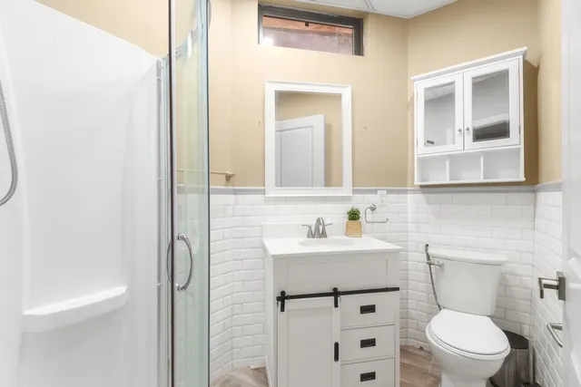 a bathroom with a toilet a sink and a mirror