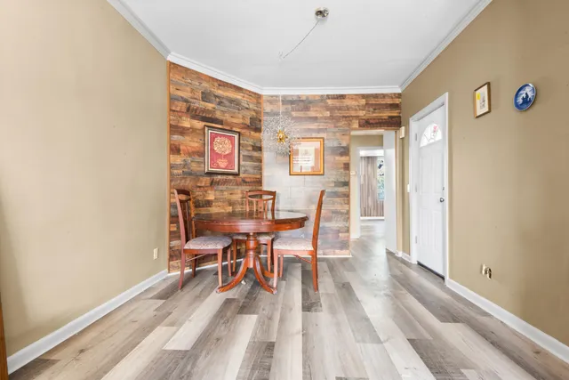 a view of a dining room with furniture and wooden floor