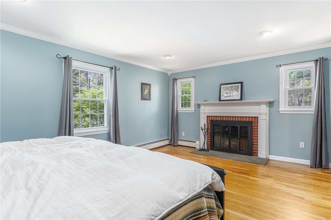 238 Nipmuc Road Scituate, RI 02825 - Photo 24 of 50 First floor primary with working wood brick fireplace