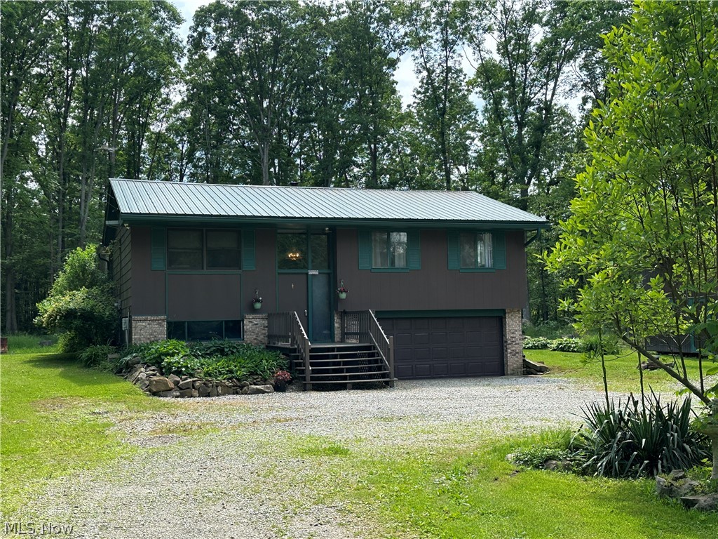 8484 Whipporwill Road Ravenna, OH 44266 - Photo 2 of 21 Raised ranch featuring a garage and a front yard