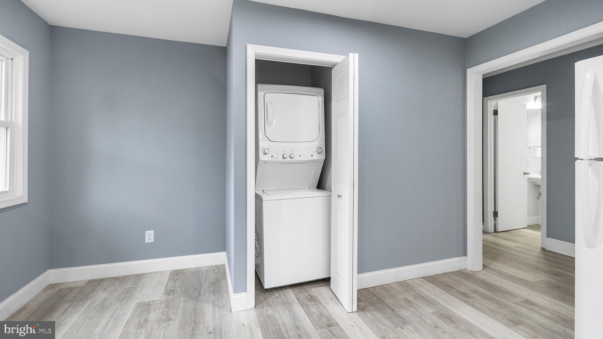 1007 Spring Avenue Salisbury, MD 21804 - Photo 5 of 13 an empty room with wooden floor and mirror