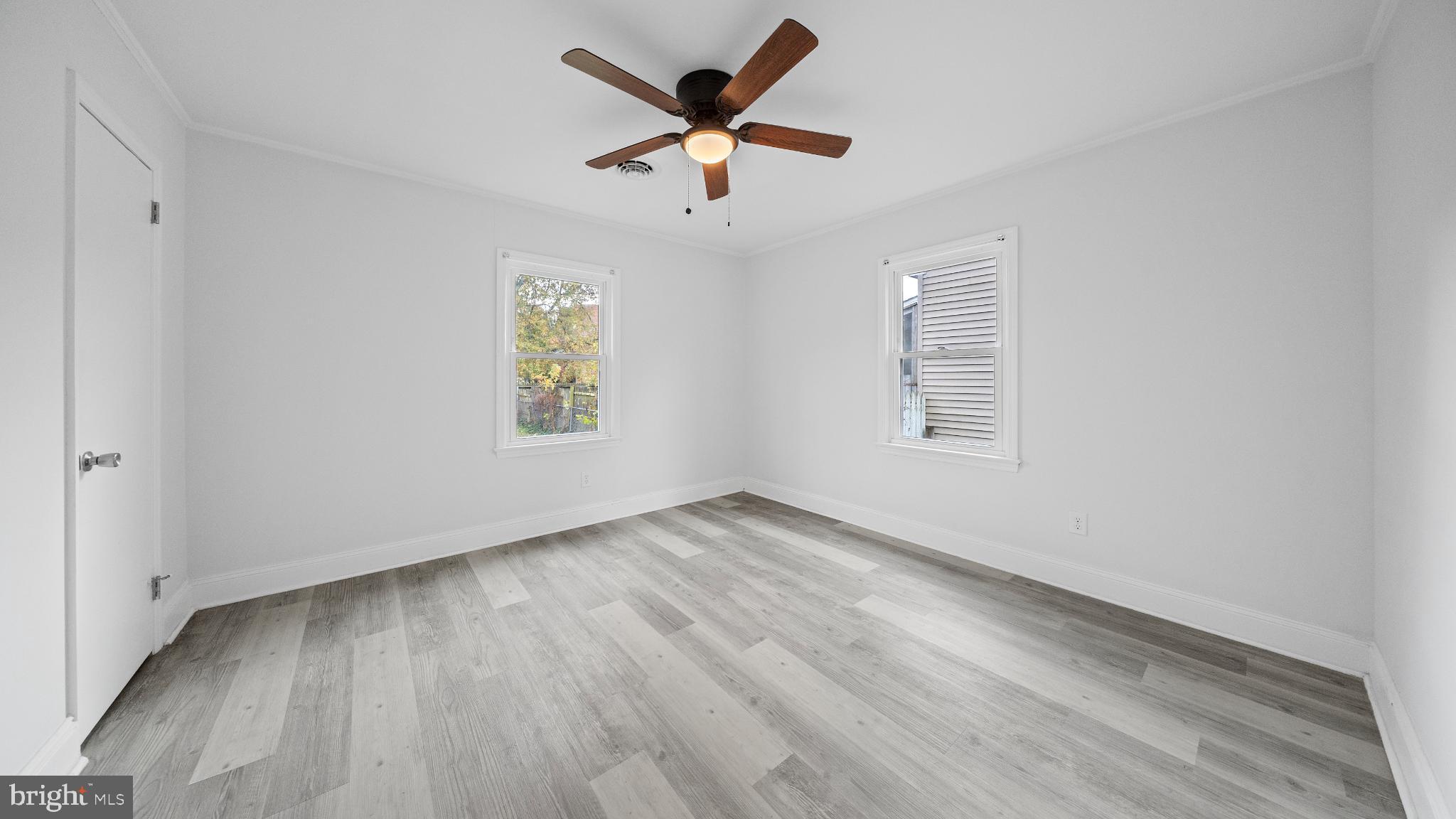 1007 Spring Avenue Salisbury, MD 21804 - Photo 8 of 13 wooden floor in an empty room with a window