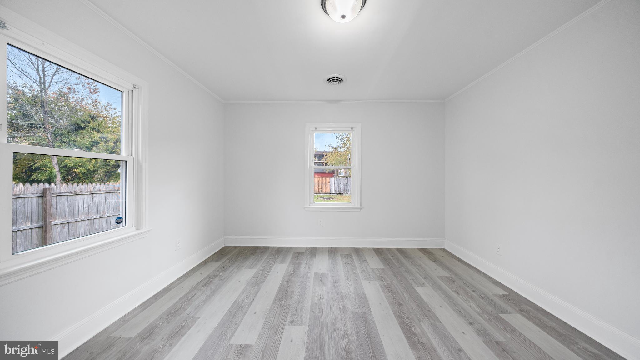 1007 Spring Avenue Salisbury, MD 21804 - Photo 9 of 13 wooden floor in an empty room with a window