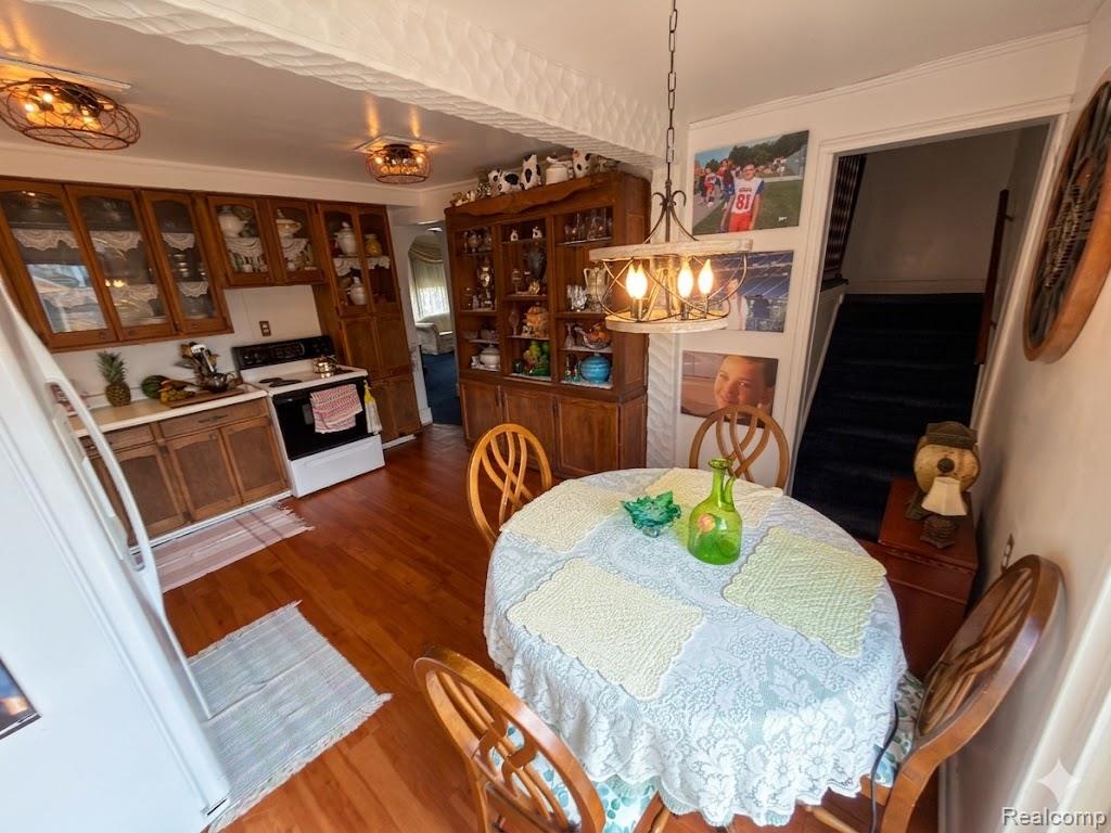 52 Maple Street River Rouge, MI 48218 - Photo 12 of 28 Dining space featuring dark wood finished floors and a chandelier