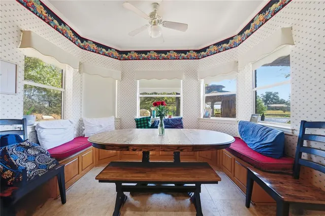 a dining room with furniture and window