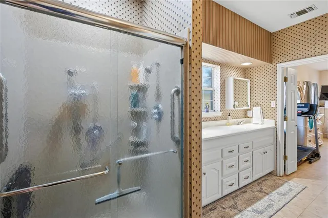a bathroom with a double vanity sink toilet and shower