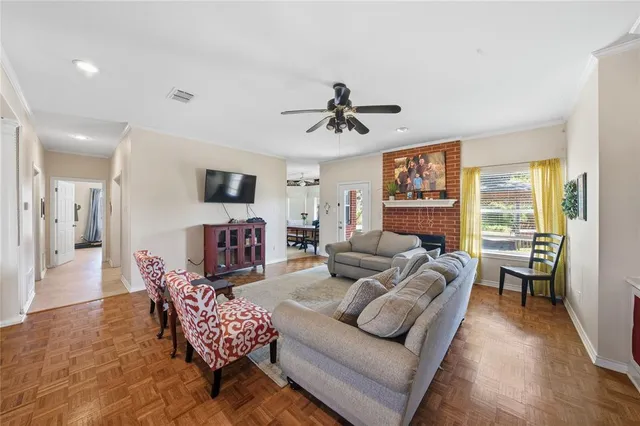 a living room with furniture flat screen tv and fireplace