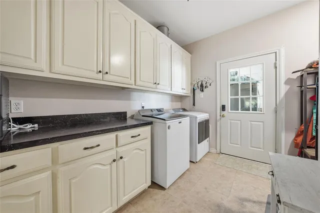a kitchen with granite countertop white cabinets and sink