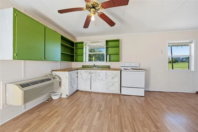 a kitchen with a cabinets and wooden floor