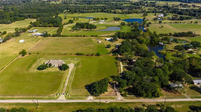 an aerial view of a residential houses with outdoor space